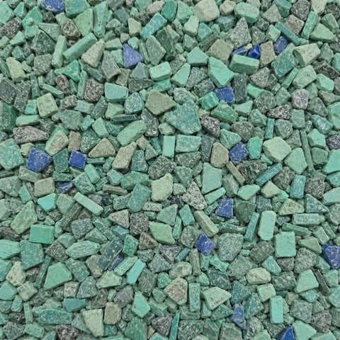 Overhead view of crushed stone and mineral chips in shades of green, gray, and blue